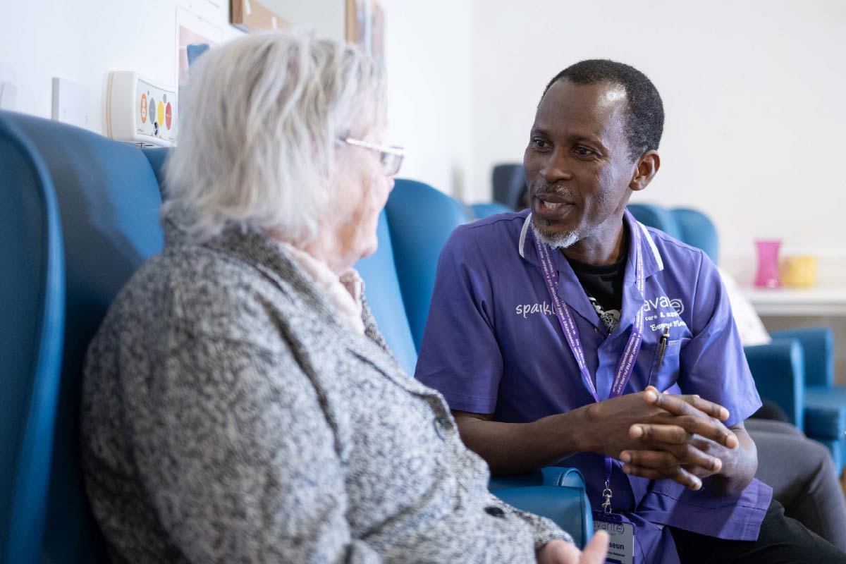 Avante Care and Support – Care Homes 016 Avante Care and Resident sitting down and talking