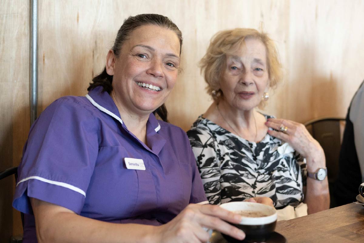 Avante Care and Support – Care Homes 028 Resident and Avante Care staff sitting a coffee shop enjoying hot chocolate drinks